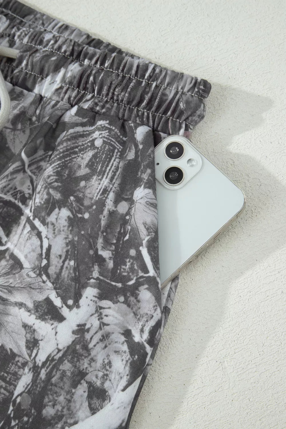 Phone case with leaf pattern on a white surface