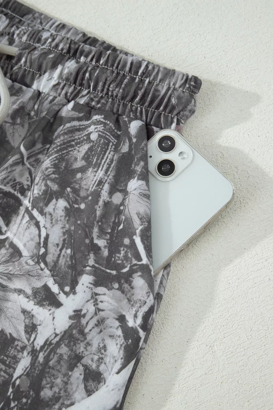 Phone case with leaf pattern on a white surface