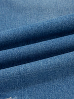 Close-up of blue denim fabric with a subtle texture