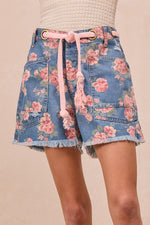 Floral denim skirt with pink drawstring on a beige background