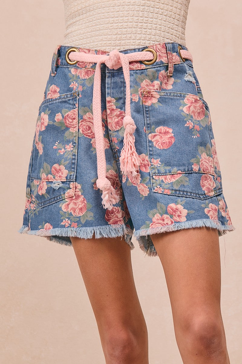Floral denim skirt with pink drawstring on a beige background