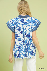 Woman wearing a blue floral top on a light green background