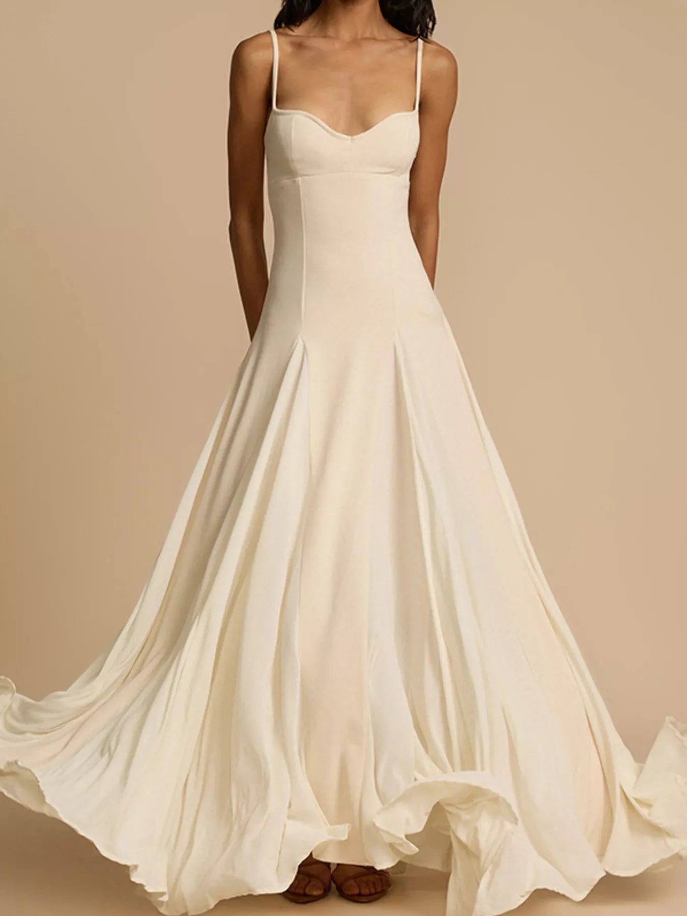 White spaghetti strap dress on a beige background