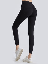 Black leggings worn by a person on a light gray background