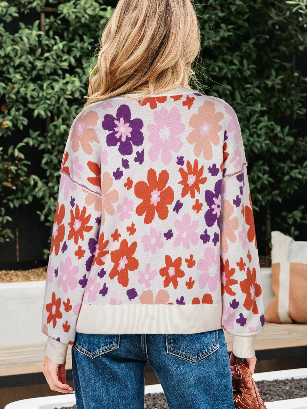 Person wearing a colorful floral sweatshirt outdoors