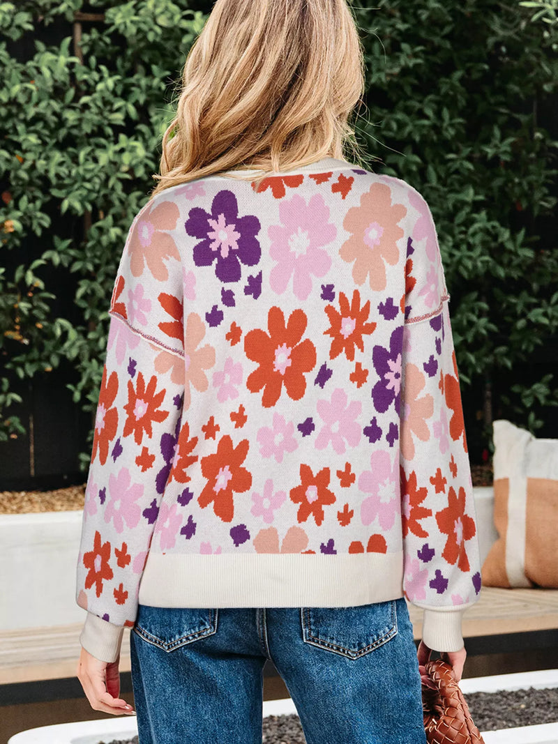 Person wearing a colorful floral sweatshirt outdoors
