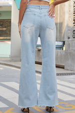 Light blue flared jeans worn by a person on a city street.