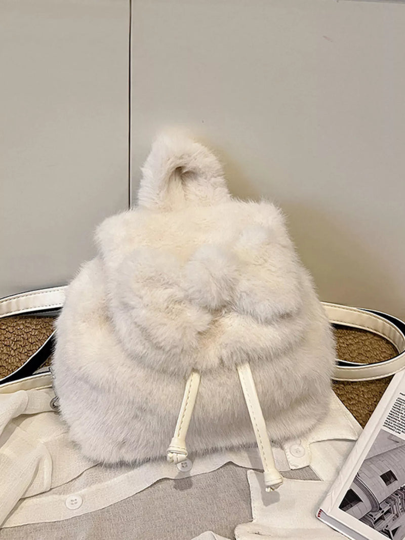 White fur backpack on a neutral background