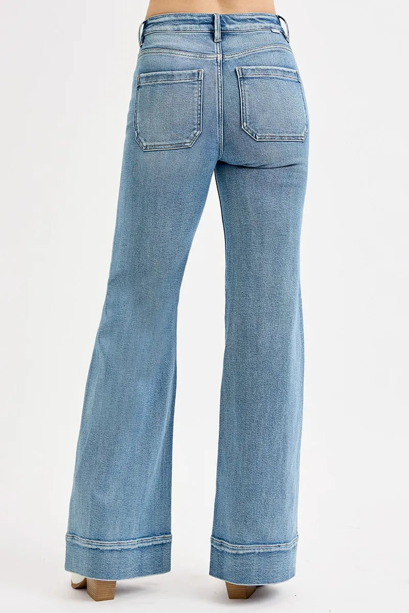 Light blue flared jeans on a white background