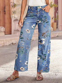 Person wearing blue floral jeans standing on a street.