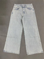 Light blue jeans on a gray background