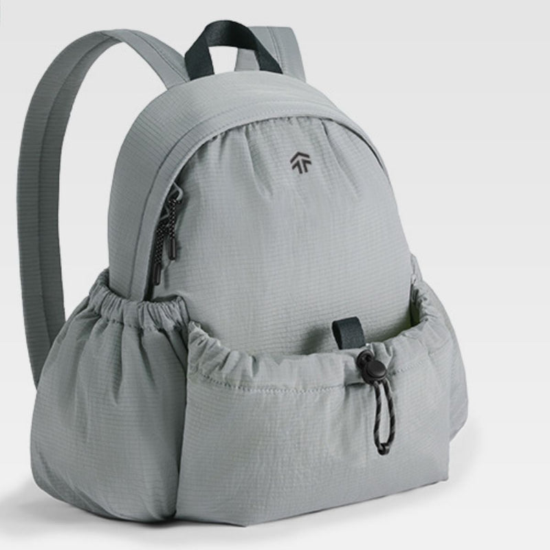 Gray backpack with a drawstring pouch on a light gray background