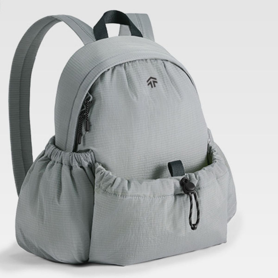 Gray backpack with a drawstring pouch on a light gray background