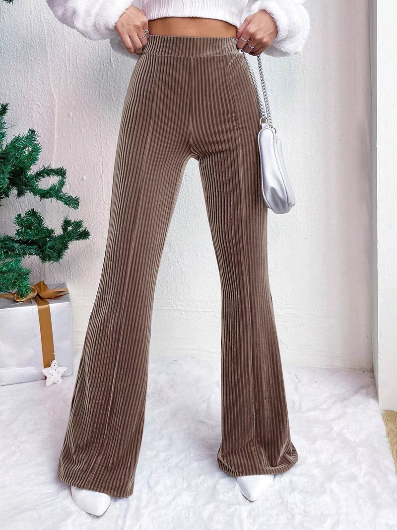 Brown ribbed wide-leg pants worn by a person with a white background
