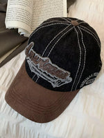 Black and brown cap with 'American' logo on a textured surface