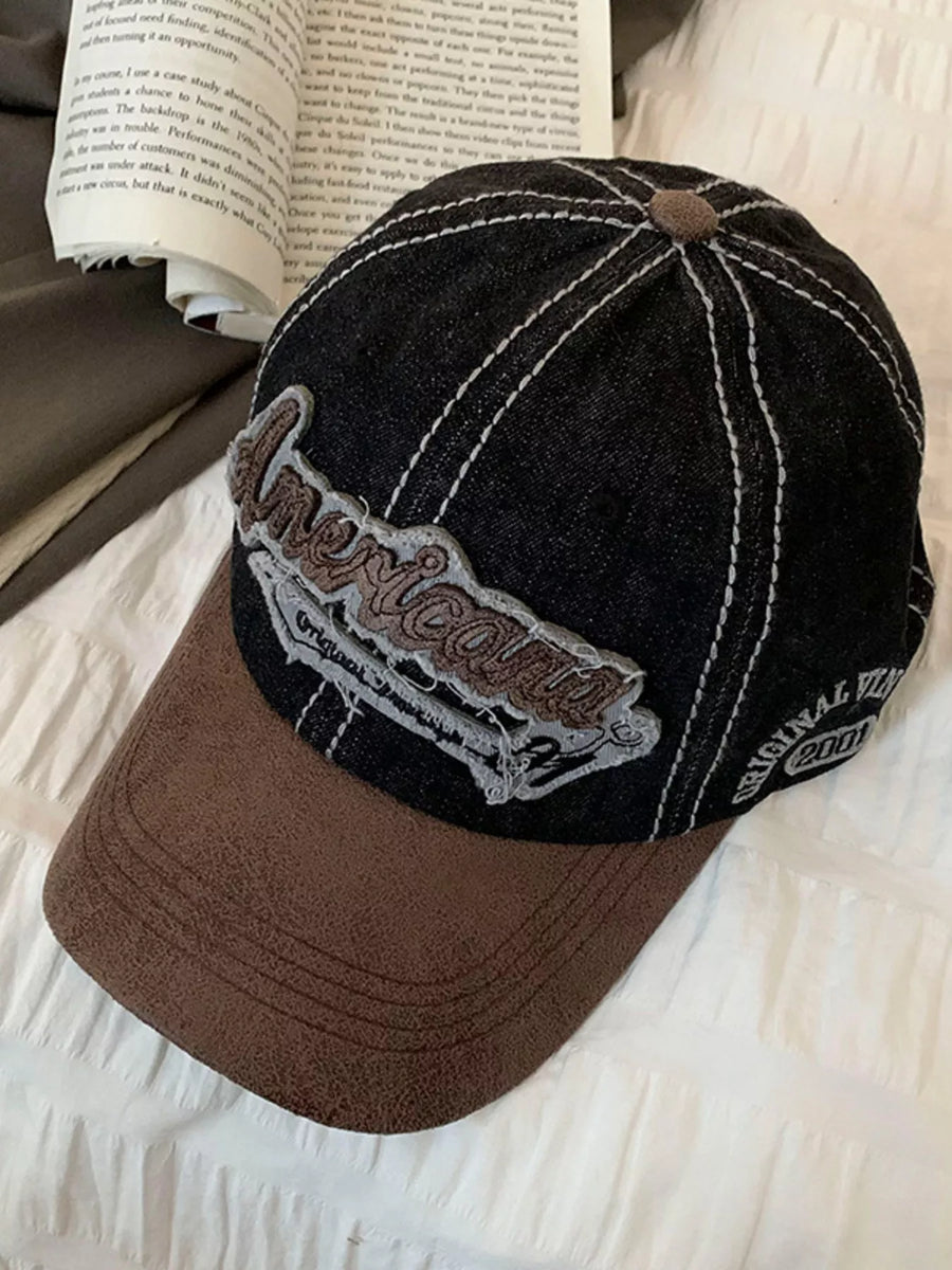 Black and brown cap with 'American' logo on a textured surface