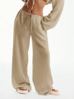 Beige wide-leg pants worn by a person on a white background