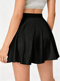 Black skirt worn by a person on a white background