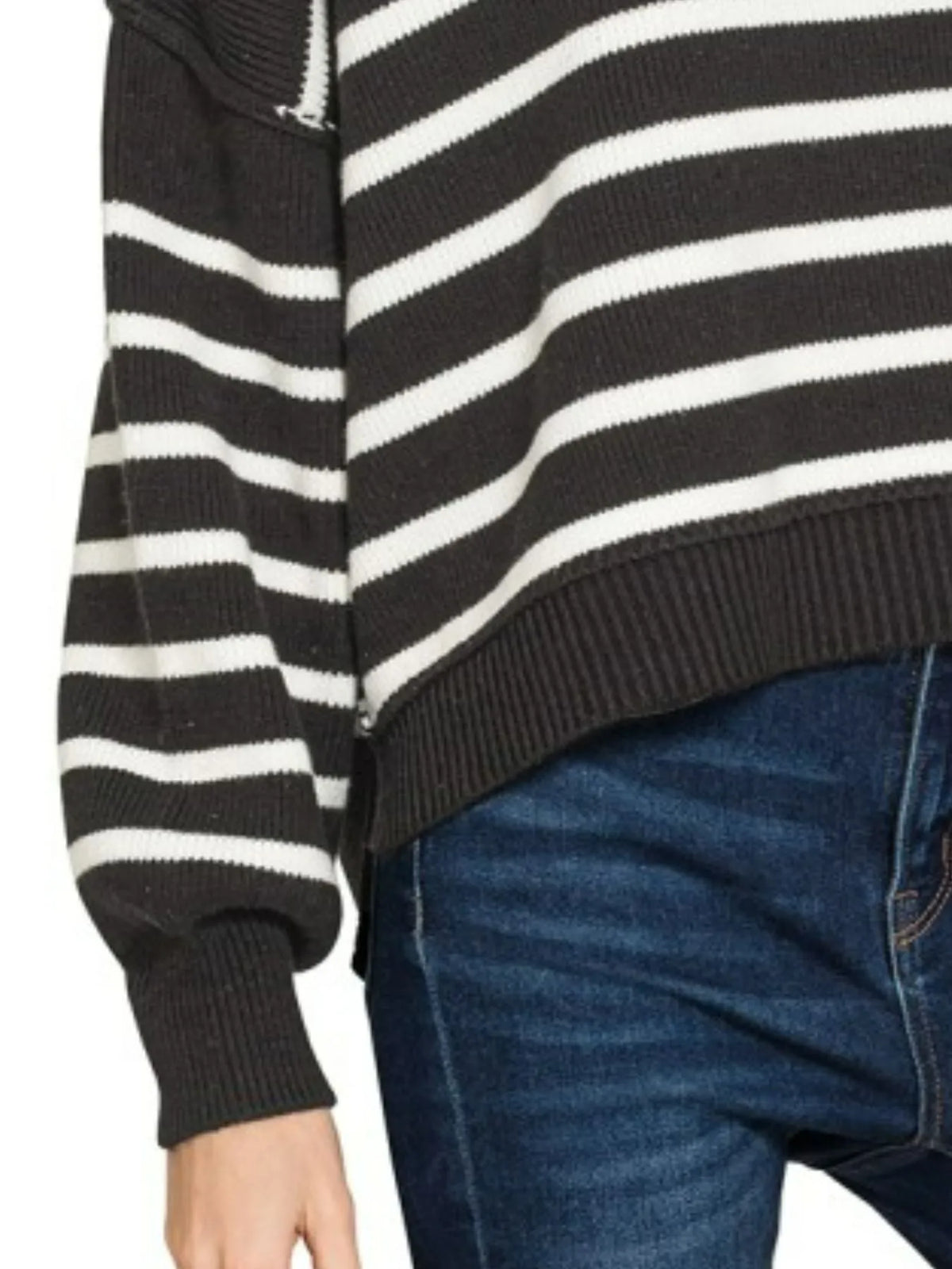 Black and white striped sweater with a person wearing blue jeans.
