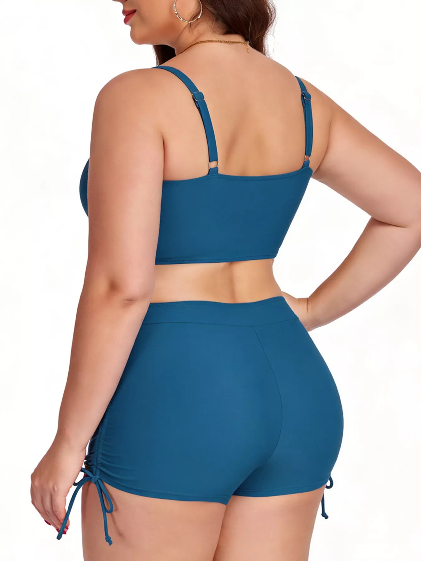 Woman wearing a blue bikini set on a white background