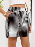 Black and white checkered shorts worn by a person with a blurred background