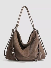 Brown leather handbag on a light gray background