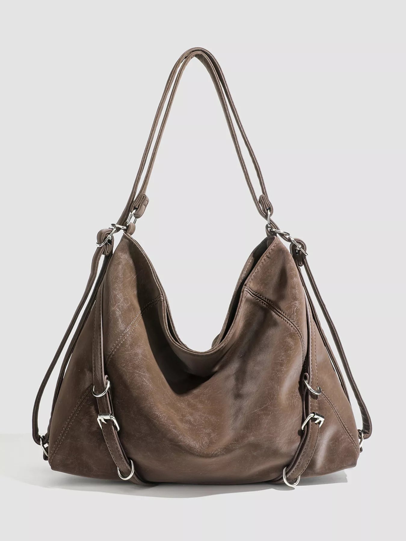 Brown leather handbag on a light gray background