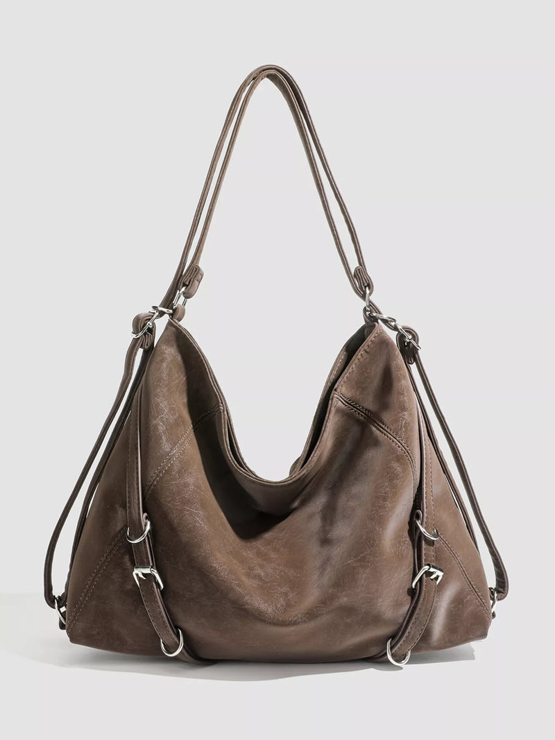 Brown leather handbag on a light gray background