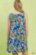 Woman wearing a colorful floral dress on a light green background