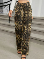 Leopard print pants worn by a person on a staircase.