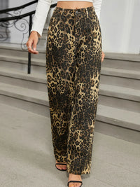 Leopard print pants worn by a person on a staircase.