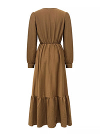 Brown dress with long sleeves and a belt on a white background