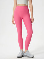 Person wearing bright pink leggings on a white background