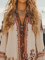 Person wearing a bohemian-style dress with intricate patterns and embroidery.