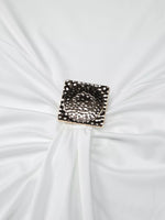Decorative brooch on a white fabric background