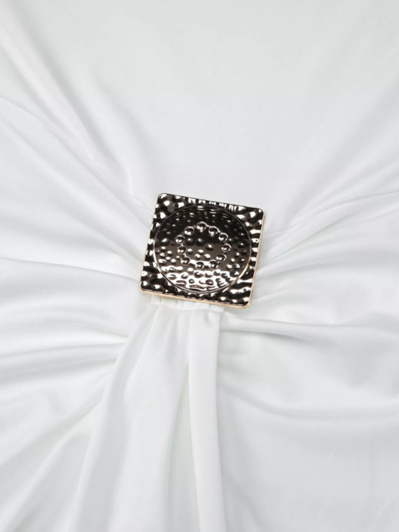 Decorative brooch on a white fabric background