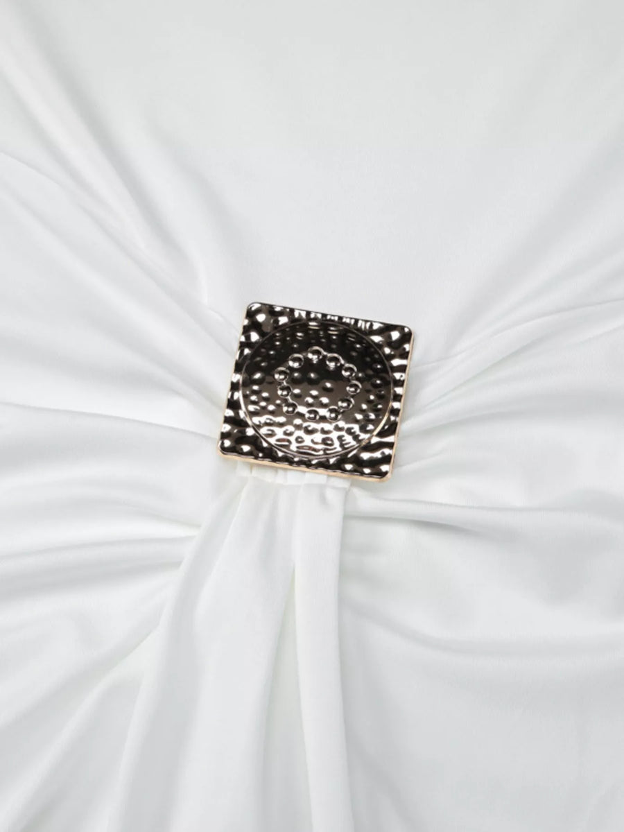 Decorative brooch on a white fabric background