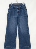Blue jeans hanging on a white background