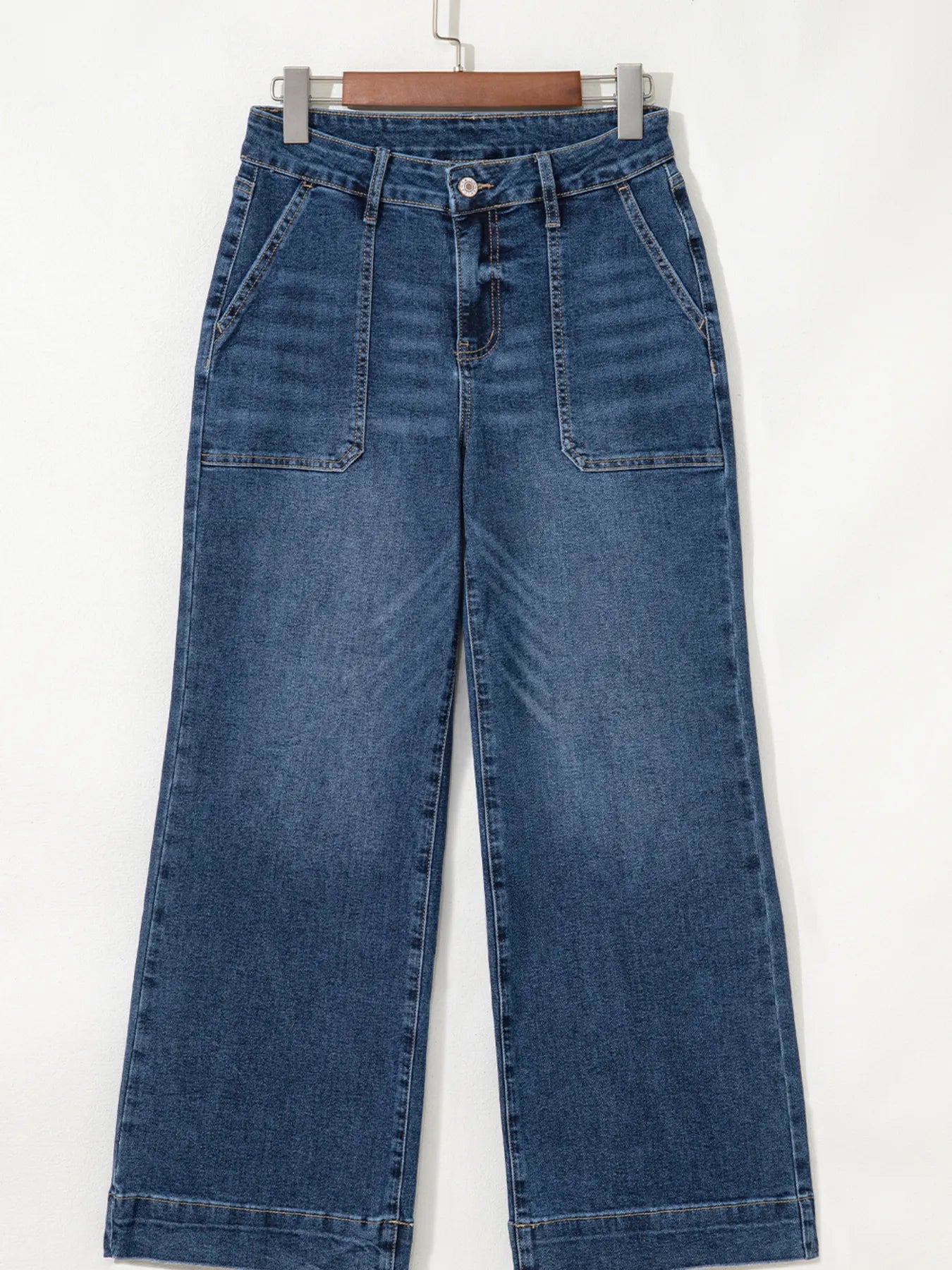 Blue jeans hanging on a white background