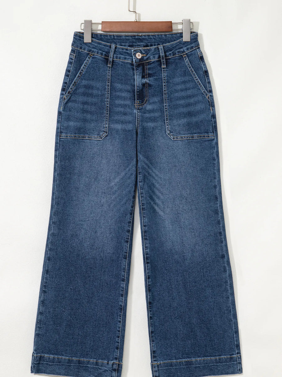 Blue jeans hanging on a white background