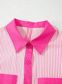 Close-up of a pink and white striped shirt with a bright pink collar on a light gray background