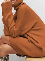 Person wearing a brown sweater with a plain background