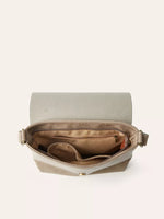 Open beige handbag with gold interior on a white background