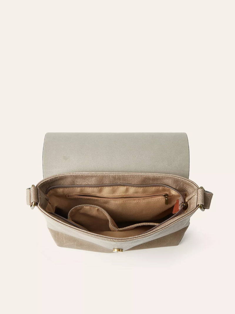 Open beige handbag with gold interior on a white background