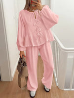 Person wearing a pink outfit with a white background
