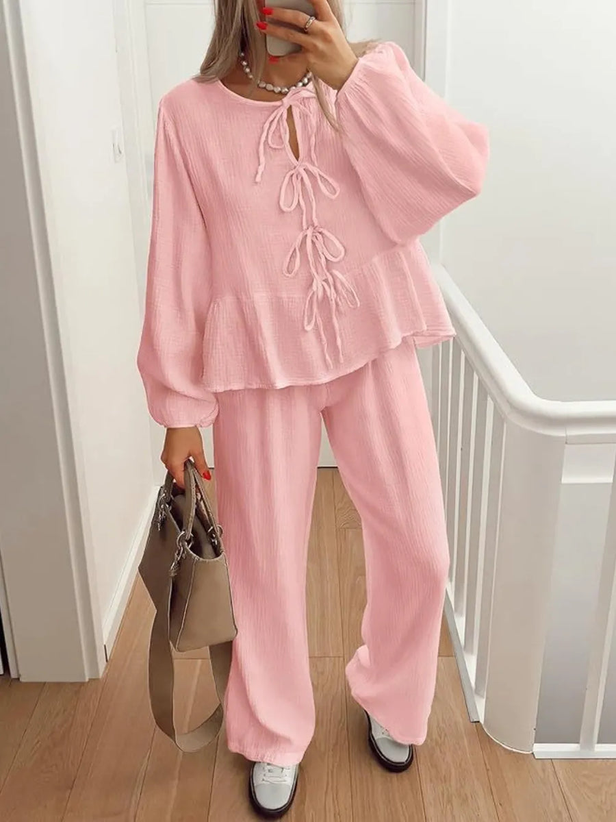 Person wearing a pink outfit with a white background