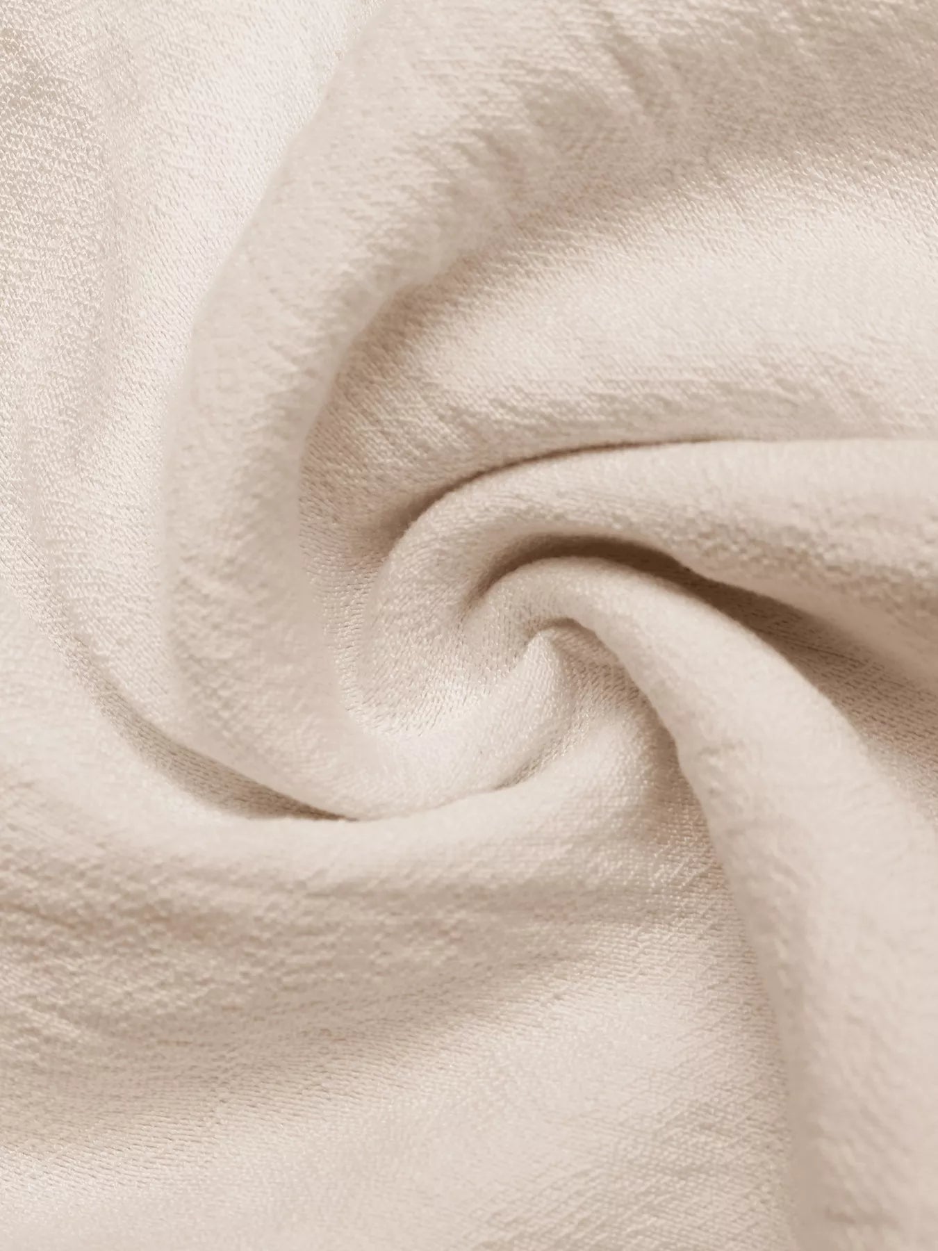 Close-up of beige fabric with a soft texture
