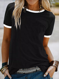 Person wearing a black t-shirt with white trim and patterned hem.