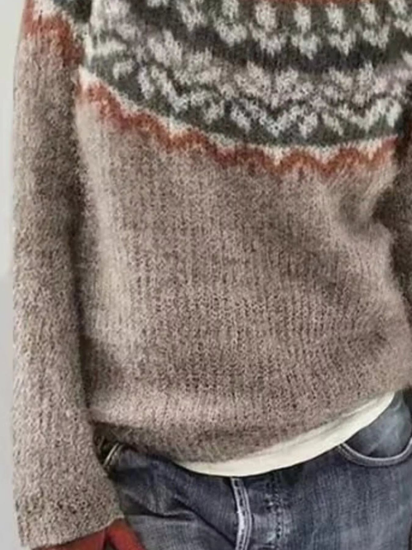 Close-up of a patterned sweater with a neutral color palette.