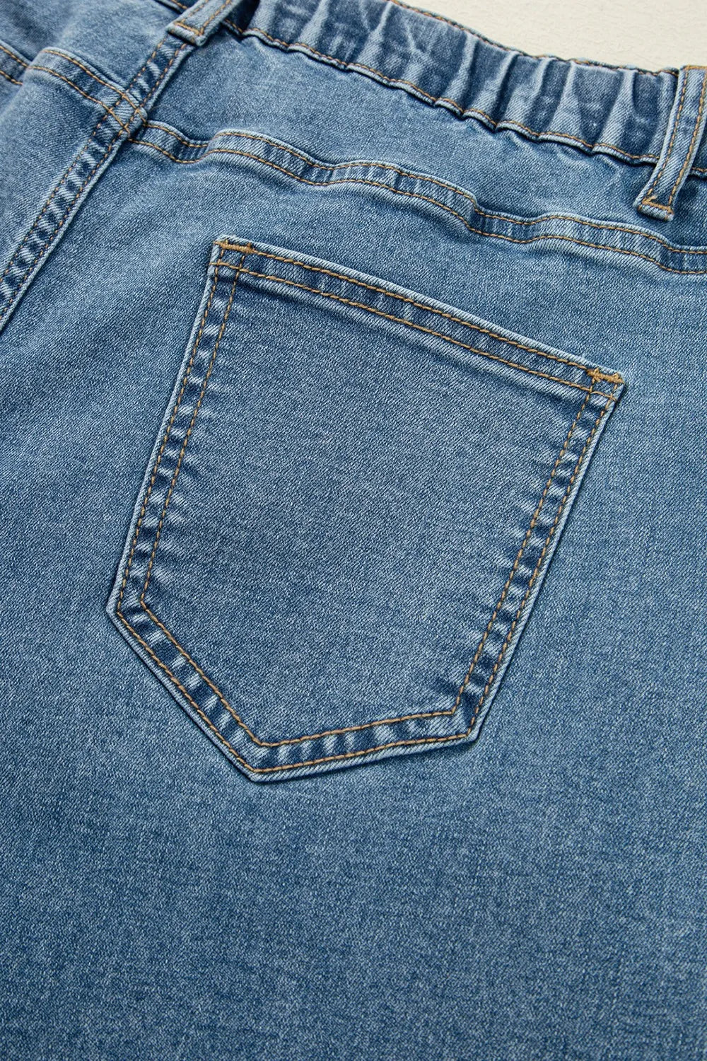 Close-up of a blue denim pocket with stitching details